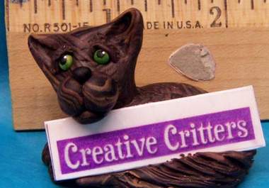 make a cute cat sculpture holding your logo, business name, or short message big2
