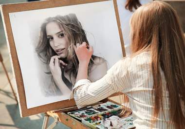 make your any photo appear as a girl is painting it with water colors in a street big2