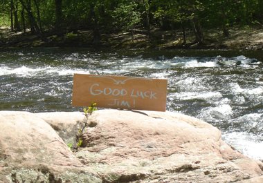 write your message on a sign by a swift river and take a high resolution photo big3