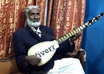 display Your Brand On a Tambura Desi Guitar In a Live Melodious Music Playing Session small1