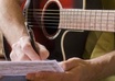 write a song with lyrics and a guitar part about absolutely anything