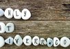 write message with stones with wood background